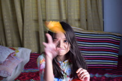 Portrait of smiling girl playing at home