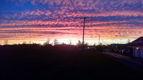 View of road against cloudy sky at sunset