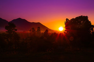 Scenic view of silhouette mountains against sky during sunset