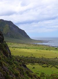 Scenic view of landscape and sea against sky