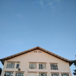 Low angle view of building against clear blue sky