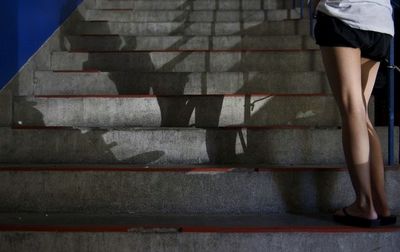 Low section of woman standing on tiled floor