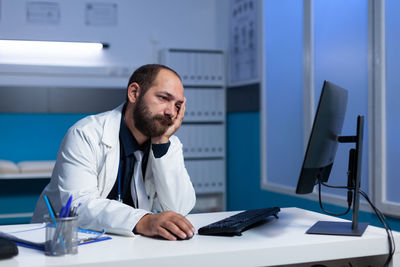 Frustrated doctor looking at computer