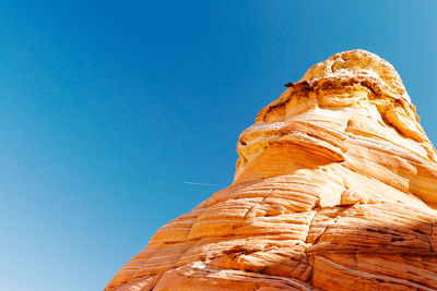 Low angle view of statue against clear blue sky