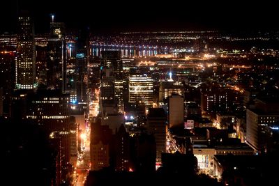Aerial view of illuminated cityscape against sky at night