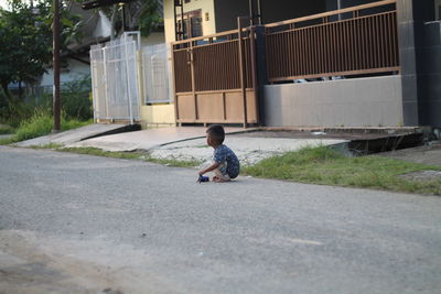 Boy playing on road in city