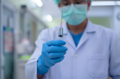 Midsection of person holding umbrella