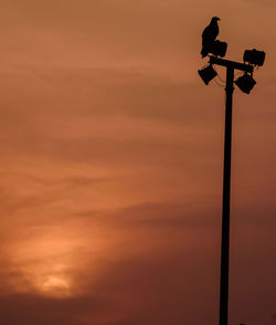 Low angle view of street light against sky during sunset