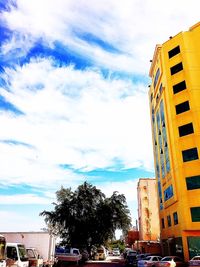 Low angle view of buildings against cloudy sky