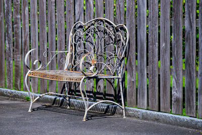 Empty bench against wall