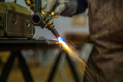 Low angle view of worker working on factory