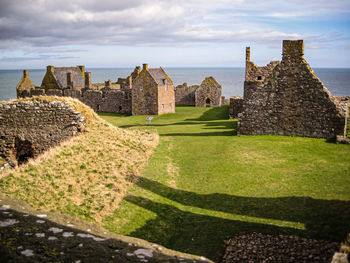 Historical medieval castle in stonehaven against the bright sky