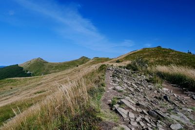 Scenic view of landscape against blue sky