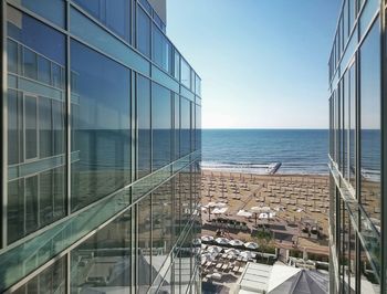 View of lido di jesolo beach seen amidst glass buildings