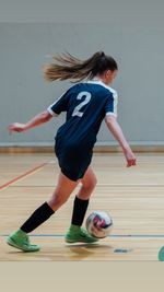 Full length of woman playing with ball