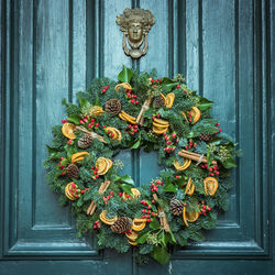 Close-up of christmas wreath hanging on door