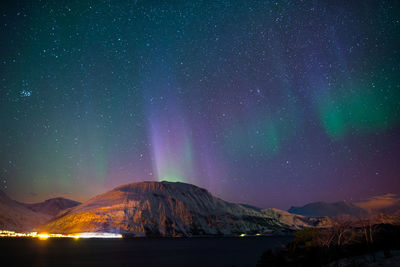 Scenic view of mountains against sky at night