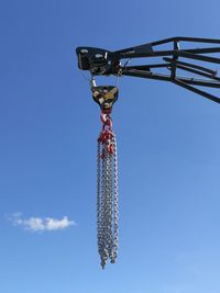 Low angle view of communications tower against blue sky