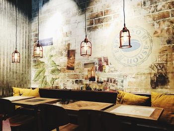 Empty chairs and table against wall in building