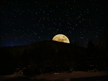 Scenic view of landscape against sky at night