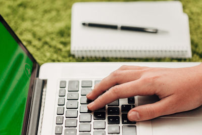 Cropped hand using laptop