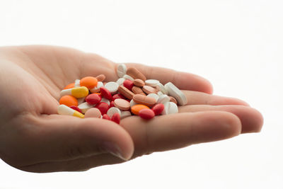 Close-up of hand holding multi colored candies