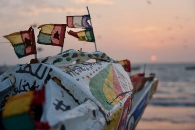 Close-up of multi colored flags on a boat on beach