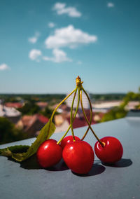 Close-up of strawberries on table against sky