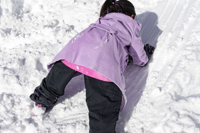 Rear view of woman on snow field