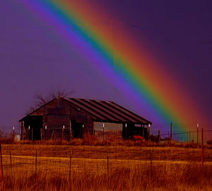 Rainbow over building against sky