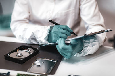 Midsection of detective working on table