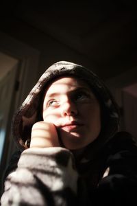 Portrait of woman in hat at home