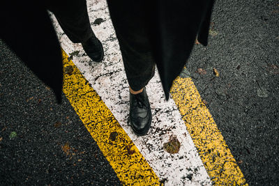 Low section of woman standing on street