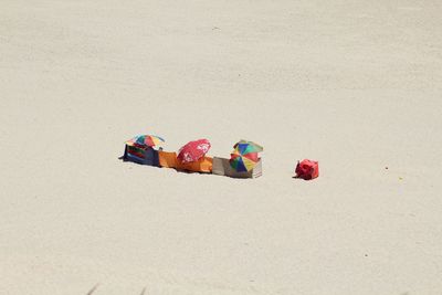 Multi colored umbrellas on sand