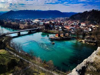 High angle view of river by townscape against sky