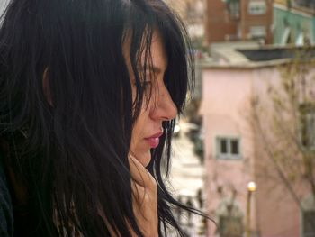 Close-up of thoughtful woman in city