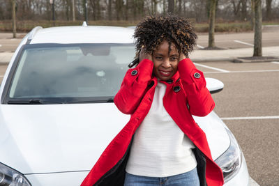 Frustrated african american woman holding her hair with her hands due to wind