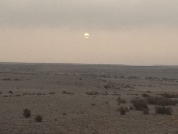 Scenic view of moon against sky at sunset