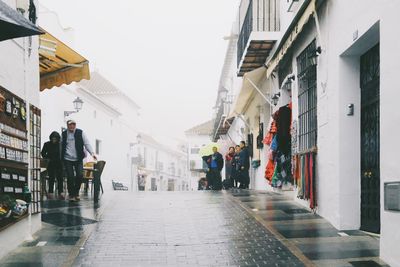 People walking on street in city