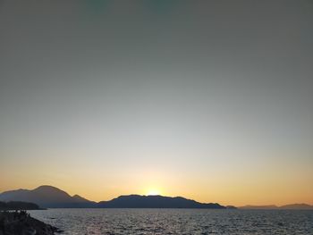 Scenic view of sea against clear sky during sunset