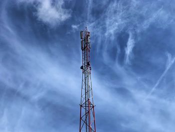 Low angle view of communications tower against sky