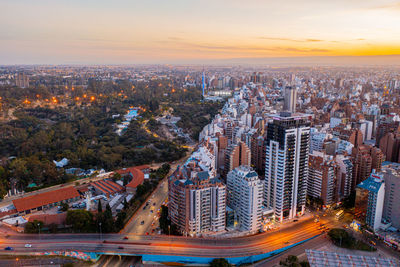 High angle view of buildings in city during sunset