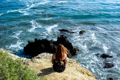 Lonely girl looking at sea in orange county california 