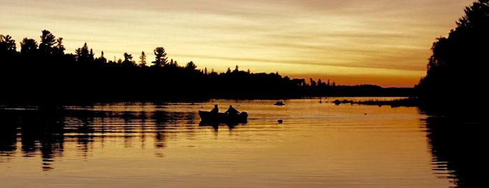 Scenic view of lake at sunset