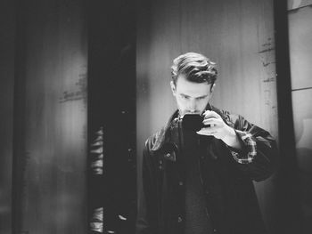 View of bearded young man taking a selfie in mirror