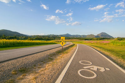 Road sign against sky