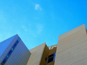 Low angle view of buildings against blue sky