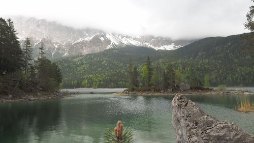 Scenic view of lake and mountains against sky