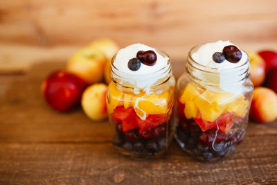 Jars with chopped fruit salad. mango, apple, grapes, blueberries and strawberries, with yogurt. 