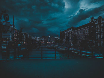 Buildings in city against sky at dusk